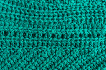 Knitted green background close up.