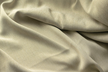 beige fabric closeup. Smooth soft curves of the fabric. Can be used as background.