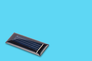 Fototapeta na wymiar One new rectangular solar cell protected of transparent silicone or resin on blue table with copy space for your text. Green or alternative or eco energy concept