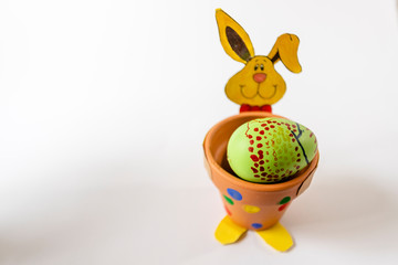 Easter background with Easter eggs and spring flowers. Top view with copy space.