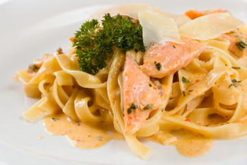 Delicious salmon pasta dish, tagliatelle noodles with Parmesan and parsley.