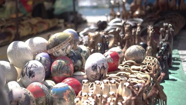 South Africa souvenir stall at flea market ostrich egg paint and animal wood sculpture