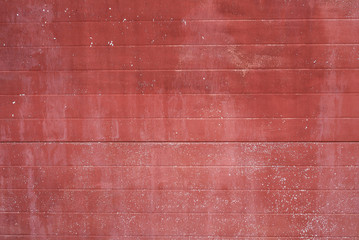 Fototapeta premium Texture of red peeling paint on the wall