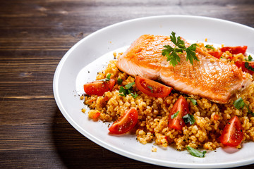 Roast salmon with groats and vegetables