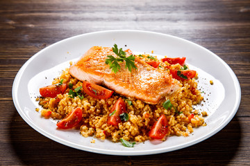 Roast salmon with groats and vegetables
