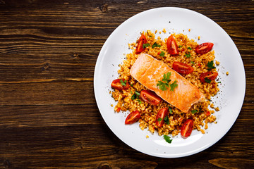 Roast salmon with groats and vegetables