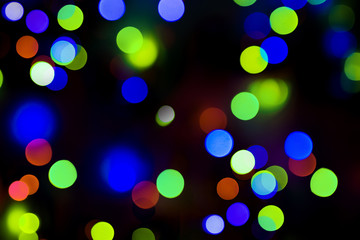 Bokeh.  Holiday background. Garland. Christmas lights. Defocused sparkles