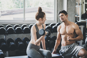 Fitness man and woman doing exercise in gym