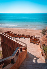 Staircase leading down to the mediterranean sea in costa dorada, Salou. Teal and orange style