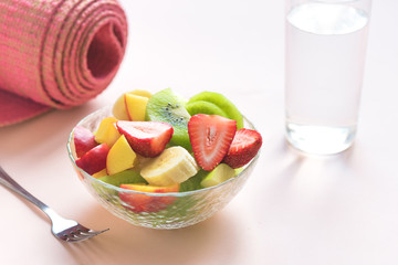Pink yoga mat and Fruit Salad