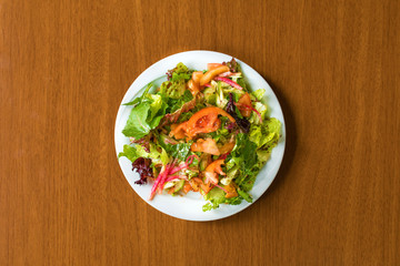Traditional Turkish or Greek Salad in plate on wooden table