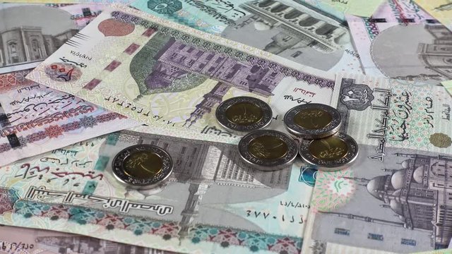 Egyptian pound notes and coins rotating. Egypt money currency. Low angle. 4K stock video footage