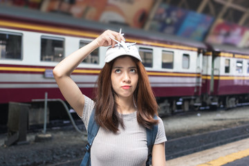 Attractive young Asian lady tourist with model airplane at train station. Travel lifestyle concept.