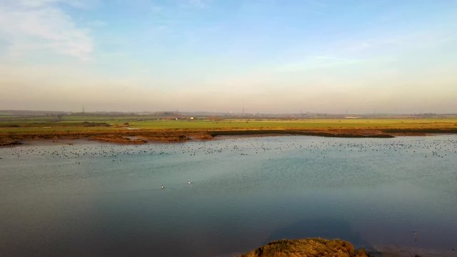 Aerial sequence depicting the wetlands at Hawbush Creek, South Woodham Ferrers with its diverse wildlife and waterfowl. Popular with walkers, visitors and naturalists alike.