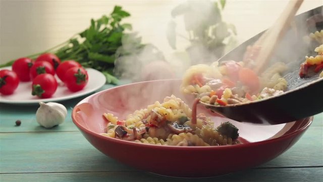 put hot fusilli pasta with vegetables on  plate close up view