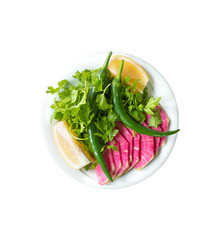Traditional Turkish Kebab Salad red radish, green pepper, parsley and lemons in plate isolated on white