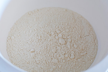 Whole wheat flour in wooden bowl. Whole-wheat flour, also wholemeal flour.