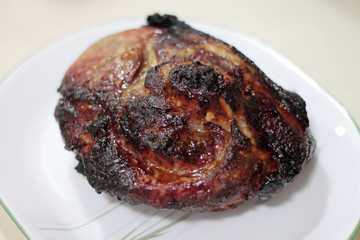 Baked pork butt on a plate.