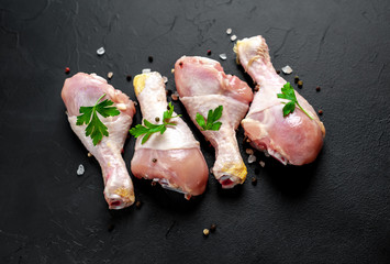 Chicken legs with spices, ready for cooking, background concrete