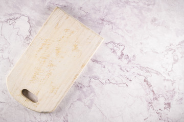 Wooden cutting board on a gray marble background