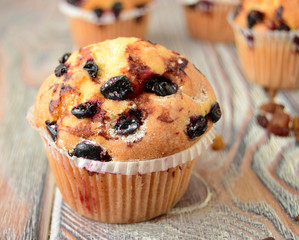 Cake is a traditional sweet dessert. Cake contains raisin. Cake is on a wooden surface. Close up.