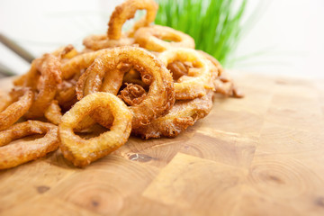 Fried Onion Rings on wood cutting board