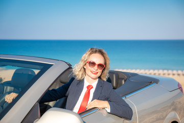 Successful young businesswoman on a beach