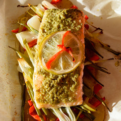 Salmon en papillote - sliced potatoes, red peppers, spring onions and a salmon filet covered with basil and a slice of lemon with habanero chilis on top