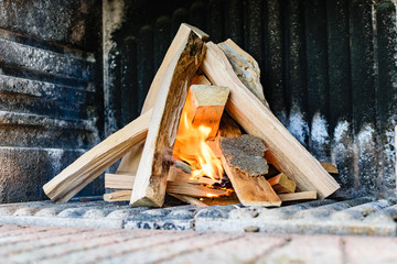 Firewood piled up and starting to burn