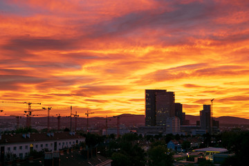Sunset over Vienna's Wienerberg area with office buildings and a construction site in the foreground