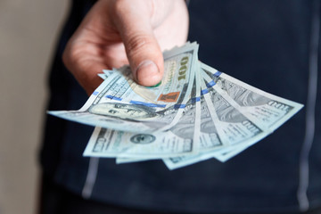 Man holdin money. Concept of savings, salary, payment and funds. Man counts cash bills..