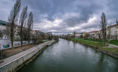 Naklejka na ściany i meble cityscape on the background of the river and clouds in the sky