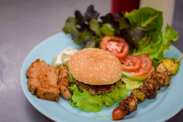 burger with french fries and salad