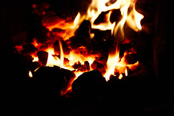 Burning and glowing pieces of wood in Fireplace