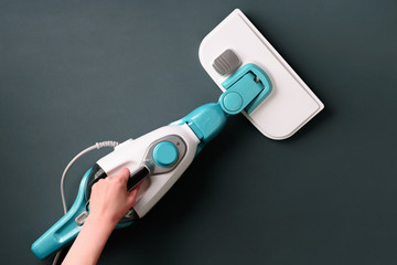 Steam cleaner mop on grey background. Top view, flat lay. Banner with copy space. Cleaning service...