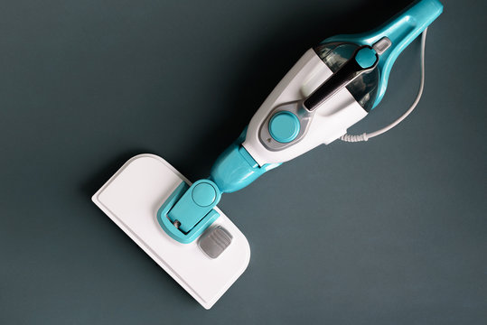 Steam cleaner mop on grey background. Top view, flat lay. Banner with copy space. Cleaning service concept