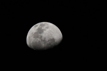 Fototapeta premium Highly zoomed waxing gibbous moon in the dark night