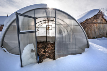 Polycarbonate greenhouse in winter. Western Siberia