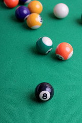 Billiard balls on a green table close-up
