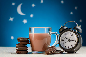 Sweet cookies, cocoa and clock