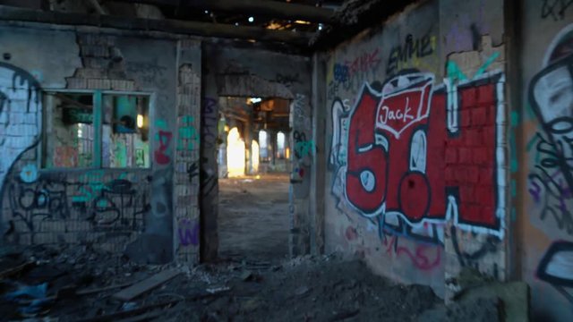 Old, abandoned and closed industrial factory building painted with graffiti