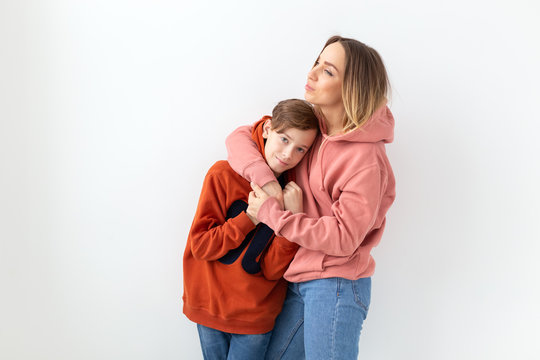 Mothers Day, Children And Family Concept - Teen Boy Hugging His Mom On White Background