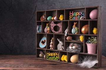 Wooden box with cells filled with Easter decor. 
