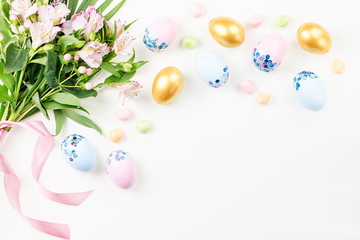 Festive Happy Easter background with decorated eggs, flowers, candy and ribbons in pastel colors on white. Copy space