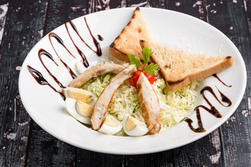 fresh tasty caesar salad appetizer in white plate