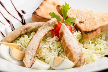 fresh tasty caesar salad appetizer in white plate