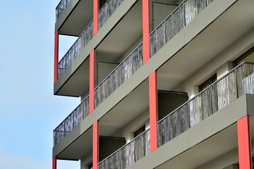 Fototapeta premium Modern apartment buildings on a sunny day with a blue sky. Facade of a modern apartment building