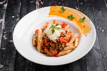 tasty vegetarian penne pasta in white plate