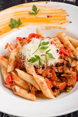 tasty vegetarian penne pasta in white plate