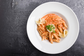 tasty penne with tuna pasta on white plate